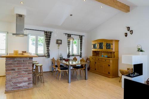a kitchen and living room with a table and chairs at Ferienwohnungen Rosenhof in Tegernsee