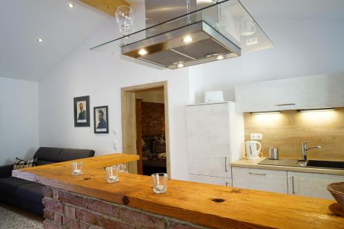 a kitchen with a wooden table in a room at Ferienwohnungen Rosenhof in Tegernsee