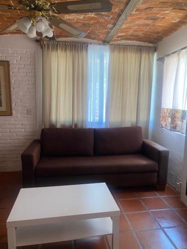 a living room with a couch and a table at Hotel Villas Ajijic, Ajijic Chapala Jalisco in Ajijic