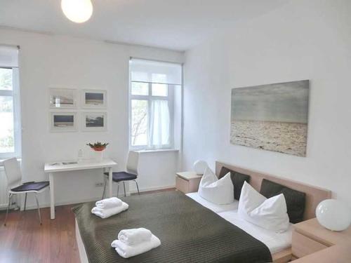 a bedroom with a bed with two towels on it at Villa Melanie in Sassnitz
