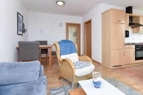 a living room with a couch and a table at Haus Hafenblick in Bensersiel