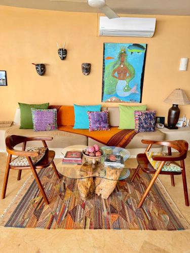 a living room with a couch and a table at Punta Majahua by PRC Hospitality in La Majahua
