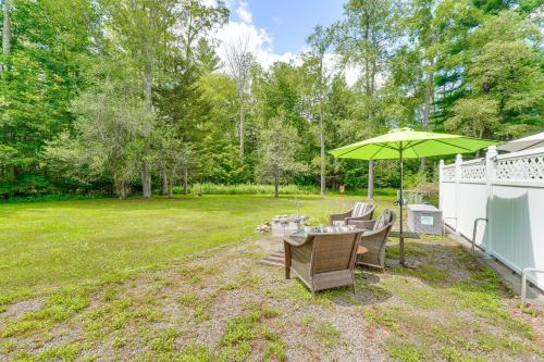 a patio with a table and an umbrella at 1 Mi to Hunter Mtn Cozy Unit on 6-Acre Property! in Hunter