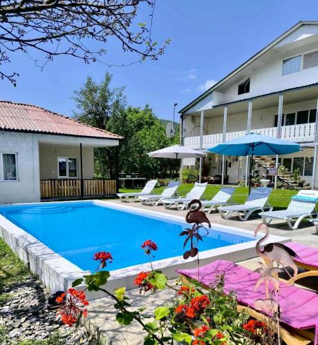 a swimming pool in front of a hotel at Cozy Family Home 