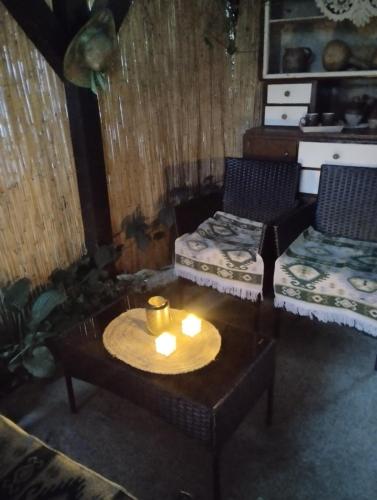 a living room with a table and two chairs at Apartman Sweet Dreams in Svrljig