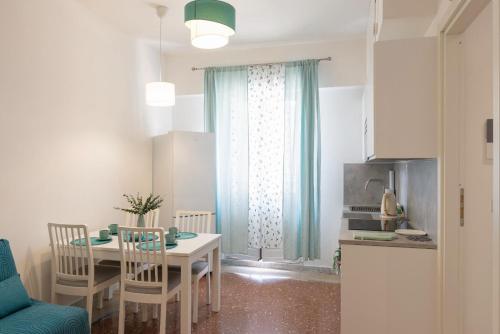 a kitchen and a dining room with a table and chairs at Sea Lily in Lido di Ostia