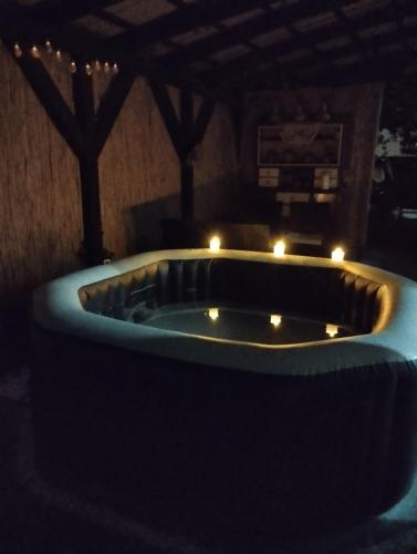 a large bathtub with candles in a room at Apartman Sweet Dreams in Svrljig