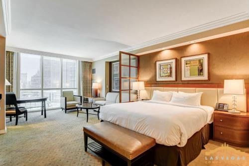 a hotel room with a large bed and a desk at MGM Signature-07-703 Strip View Jacuzzi Studio in Las Vegas