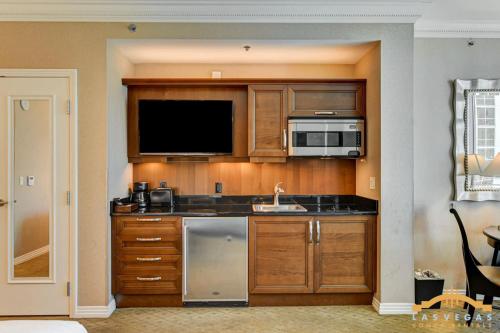 a kitchen with a sink and a microwave at MGM Signature-07-703 Strip View Jacuzzi Studio in Las Vegas