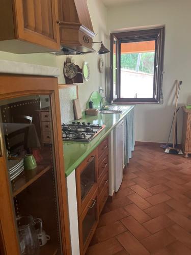 a kitchen with a sink and a stove top oven at Casale la COLLINA DEI CILIEGI in Acquapendente