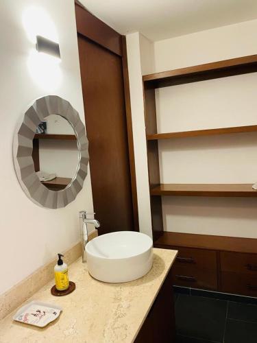 a bathroom with a sink and a mirror on a counter at Northtown San Ramón in Mérida