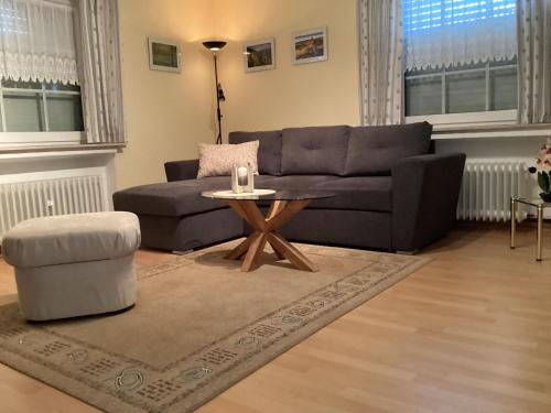 a living room with a couch and a table at Ferienwohnung Krapohl in Bad Harzburg
