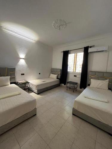 Habitación grande con 2 camas y sofá en Ammour Apartment, en Chefchaouen