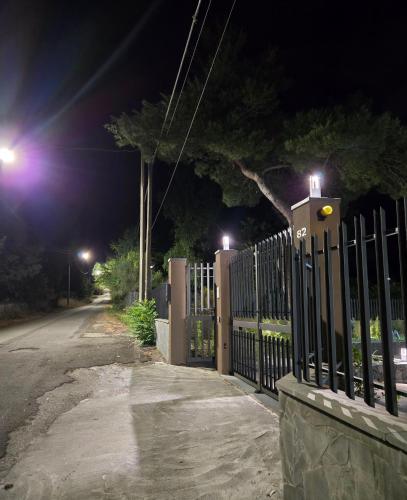 a fence next to a street at night with lights at ETNAGLOW Luxory Sicilian Villa in Nicolosi