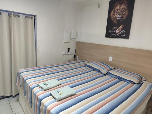 a bedroom with a bed with two pillows on it at Pousada 4 Estações in Botucatu