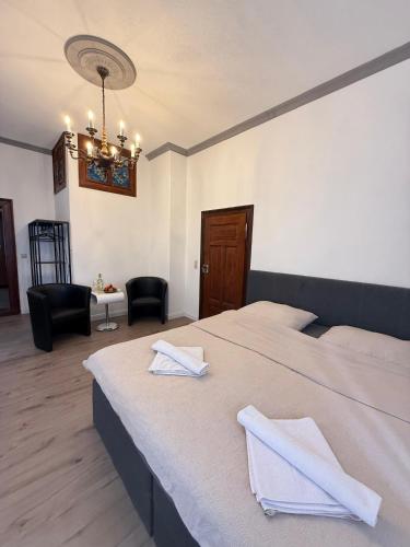 a bedroom with two beds with white towels on them at CG Haensch in Großschönau