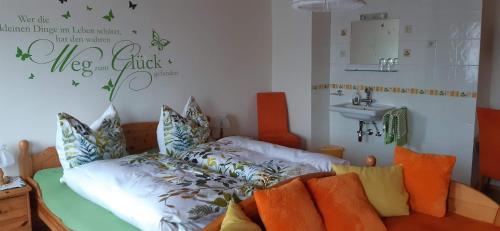 a room with a bed with pillows and a sink at Ferienhaus Tschernitz in Pruggern