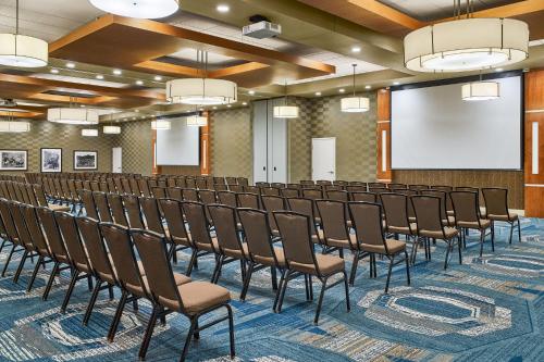 a conference room with chairs and a projection screen at SpringHill Suites by Marriott Deadwood in Deadwood