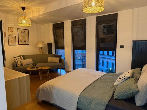 a bedroom with a bed and a living room at Zs Apartment in Tuzla