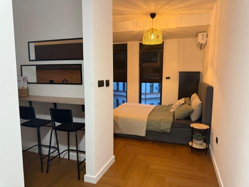 a bedroom with a bed and a table and chairs at Zs Apartment in Tuzla