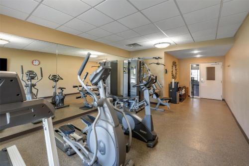 a gym with treadmills and ellipticals in a building at Best Western Plus College Park Hotel in College Park