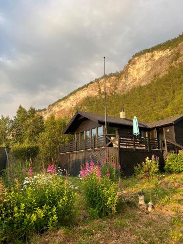 a house with a mountain in the background at High standard and beautiful view in Tennevika