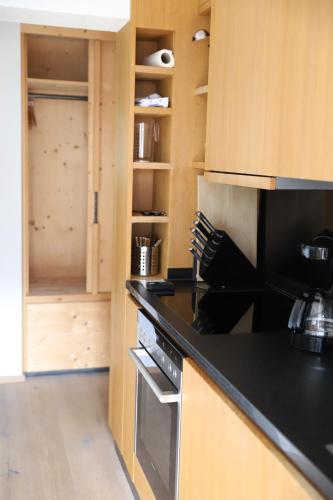 a kitchen with a black counter top and a stove at Der Steinadler in Umhausen