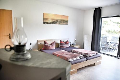 a bedroom with a bed with two pillows on it at Haff-Ostseeferienhaus Nebengebäude in Mönkebude