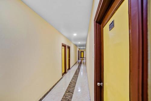 比拉斯布尔Collection O Suvidha的一条空的走廊,有黄色和白色的墙壁