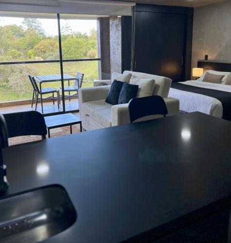 a living room with two beds and a couch at Hotel Rioverde-Suite localizada a 5 minutos del aeropuerto Internacional in Rionegro