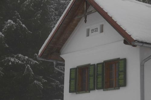 a house with stained glass windows in front of a mountain at Kellerstöckl Leitner in Strem
