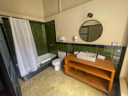 a bathroom with a sink and a toilet and a mirror at Viajero Lima - Barranco Hostel in Lima