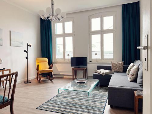 a living room with a couch and a glass table at Haus Seebaer in Ahlbeck