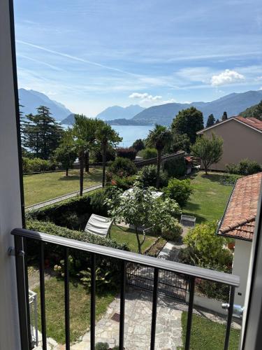 a room with a balcony with a view of a yard at Villa Scala Menaggio in Menaggio