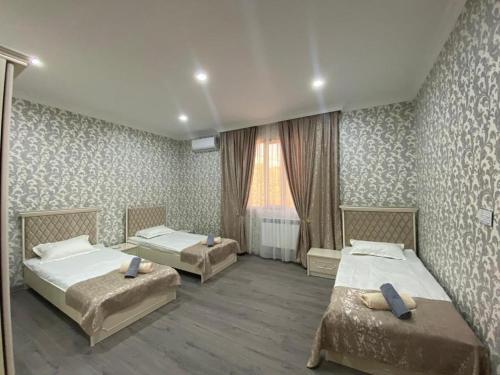 a bedroom with two beds and a window at Twin villas VSL in Gabala