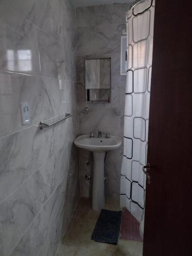 a white bathroom with a sink and a mirror at Cabaña 4 Brisas del Valle in Tafí del Valle