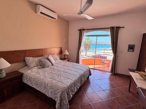 a bedroom with a bed and a view of the ocean at Casa Mar, Near Balandra Beach in Pichilnque
