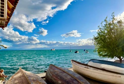 two boats sitting on the shore of a body of water at Sesa Appartment in Struga