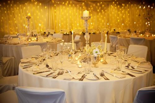 a table with white table cloths and silverware on it at Aston Hall Hotel, BW Signature Collection in Sheffield