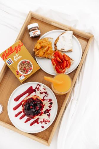 a tray of food with two plates of food at Centoquindici Rooms & Suite in Montesilvano