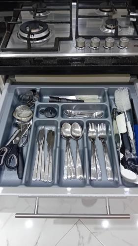 a drawer filled with utensils in an oven at Appartement Etoilé in Tetouan
