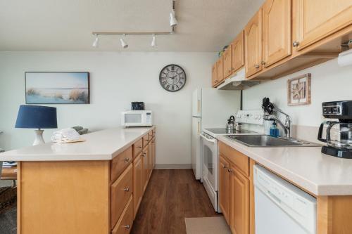 a kitchen with a sink and a refrigerator at Ocean Terrace Condominiums in Lincoln City