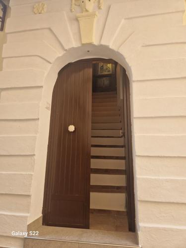 una puerta de madera con escaleras en un edificio en B&B Al gafio da Aurora, en Corigliano Calabro
