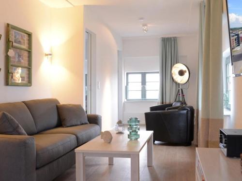a living room with a couch and a table at Ohlerich Speicher App_ 40 in Wismar