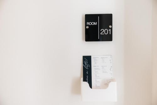 a black and white sign on a wall at Centoquindici Rooms & Suite in Montesilvano