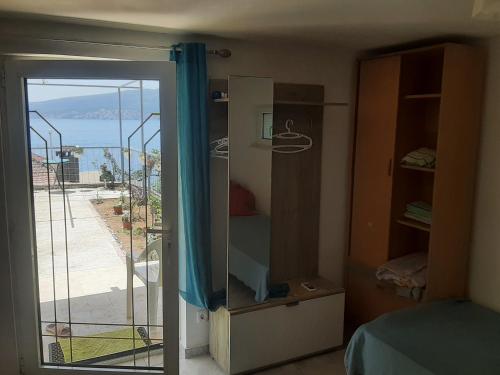 a room with a sliding glass door to a balcony at Апарты в Биеле 80 м от моря in Bijela