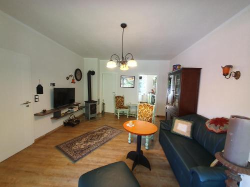a living room with a couch and a table at Ferienwohnung Am Traumgarten, 35646 in Uplengen
