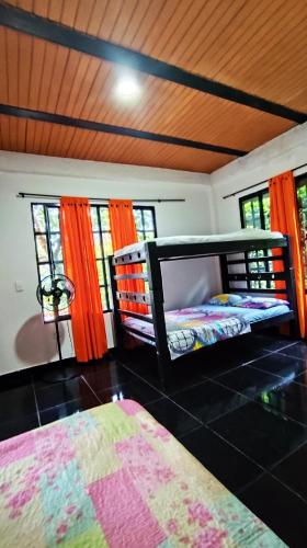 a bedroom with two beds in a room with windows at Finca la Campechana in Restrepo