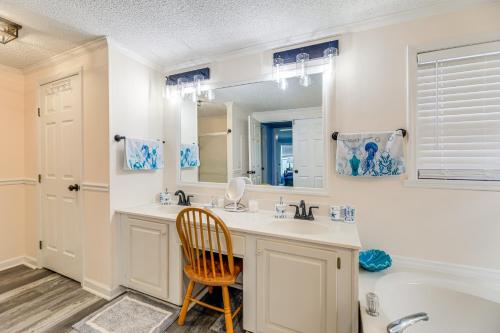 a bathroom with a sink and a mirror and a tub at 7 Mi to Beach! Sneads Ferry Family Home with Hot Tub in Sneads Ferry