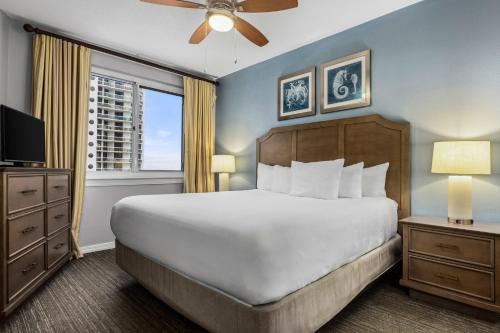 a bedroom with a large bed and a window at Club Wyndham at Majestic Sun in Destin